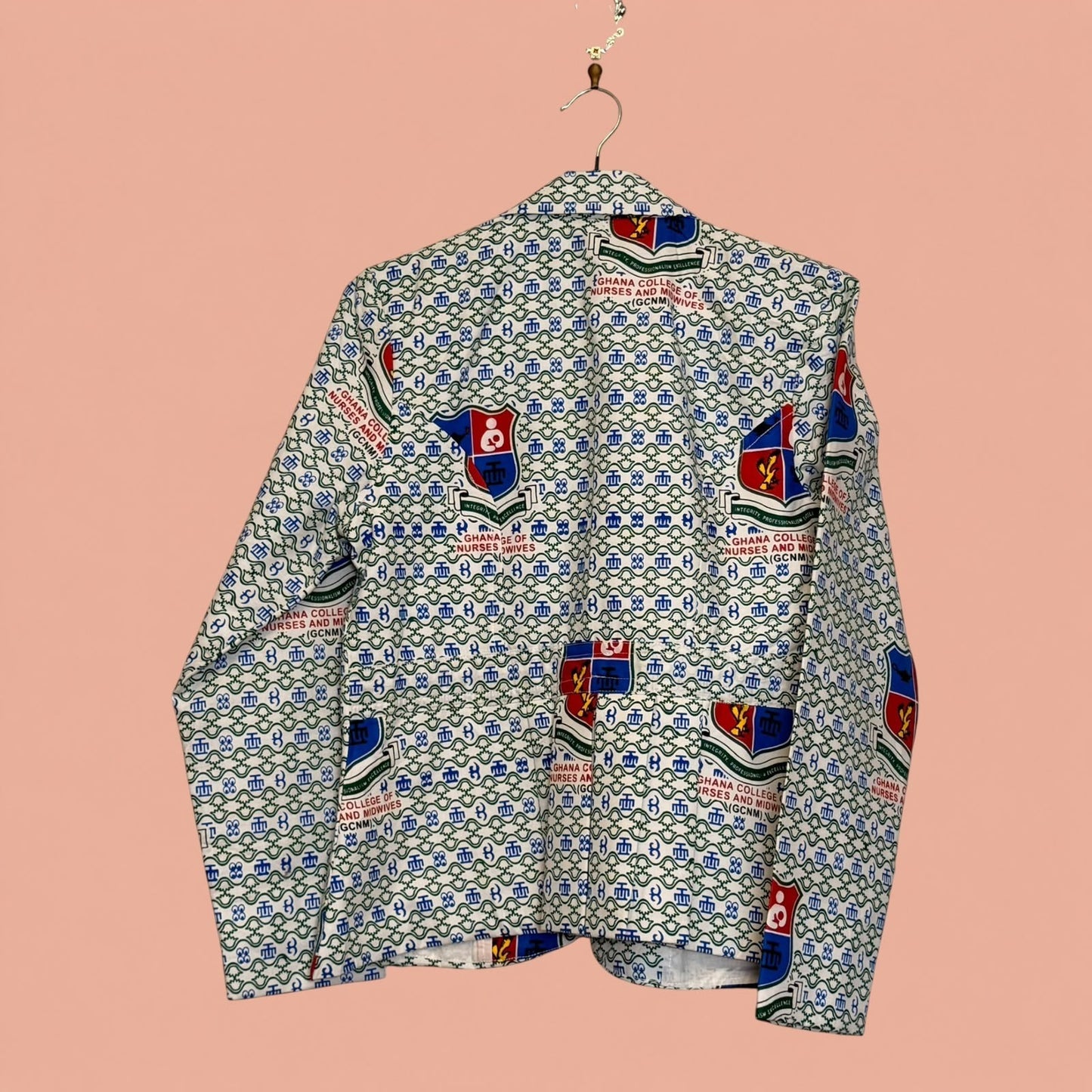 Blazer de segunda mano Tuclosetrenovado.cl con estampado gráfico de logotipos y patrones geométricos en tonos azul y rojo