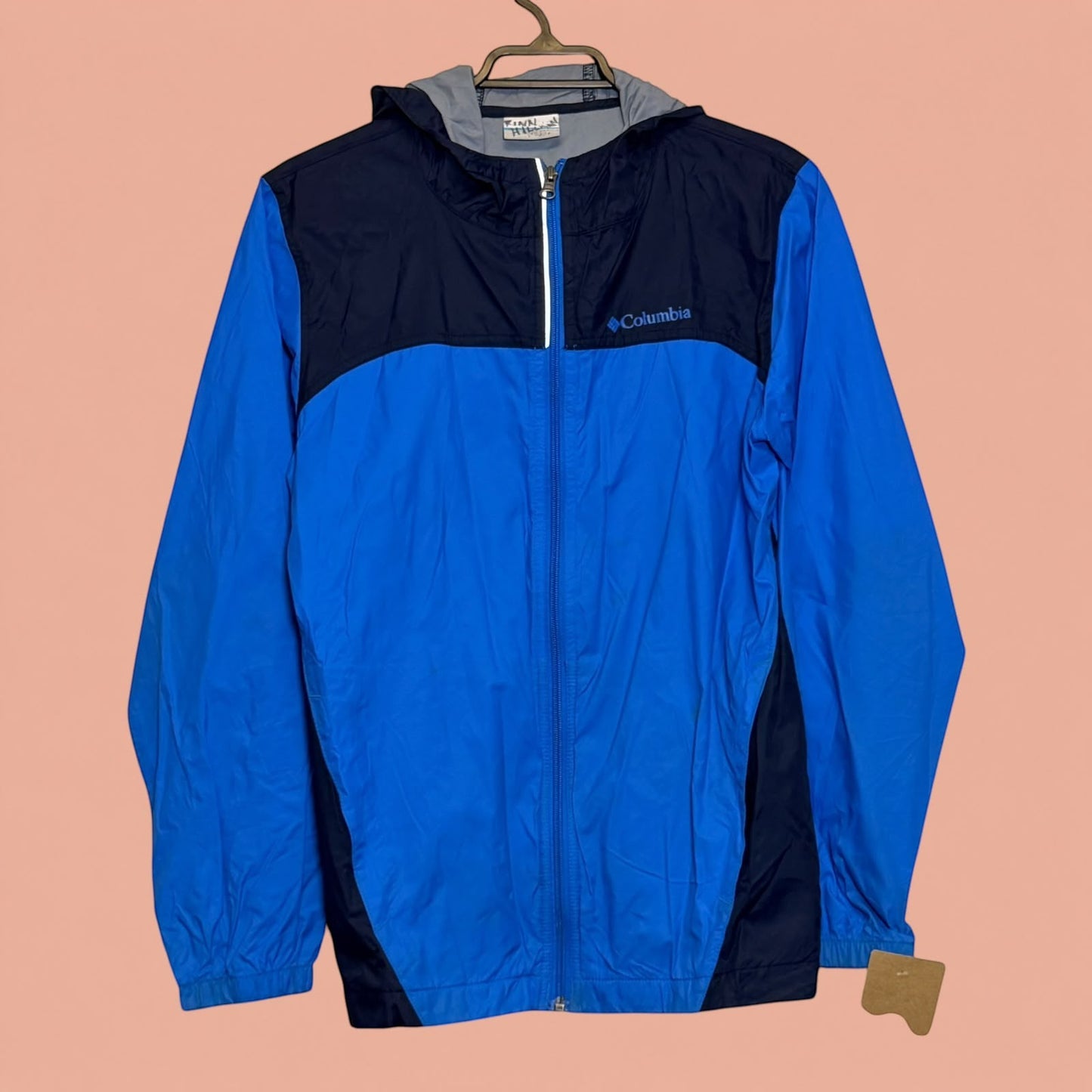 Chaqueta cortavientos Columbia de Tuclosetrenovado.cl en azul y azul marino con capucha y cierre frontal