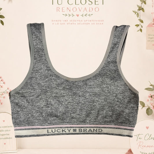 Top deportivo gris jaspeado de Lucky Brand con banda elástica inferior, disponible en Tuclosetrenovado.cl